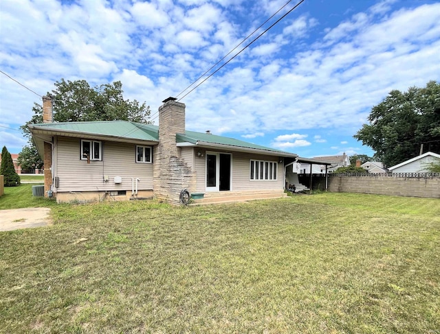 back of property with a yard