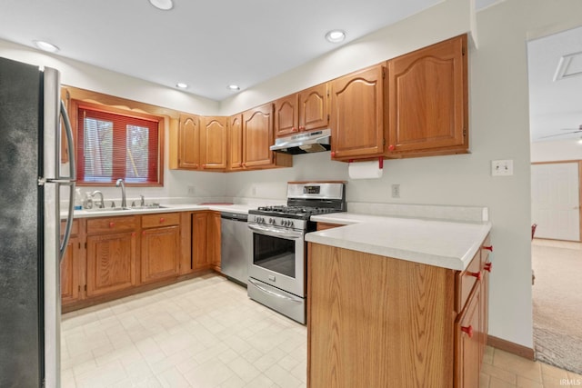 kitchen with ceiling fan, kitchen peninsula, light tile patterned floors, stainless steel appliances, and sink