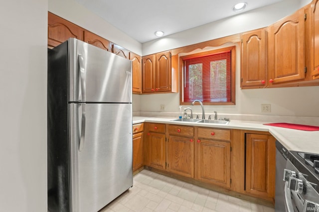 kitchen featuring light tile patterned floors, appliances with stainless steel finishes, and sink