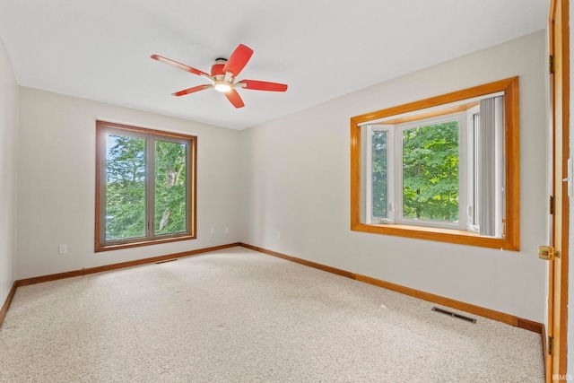 empty room with ceiling fan and carpet floors