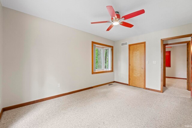 unfurnished bedroom with ceiling fan and light carpet