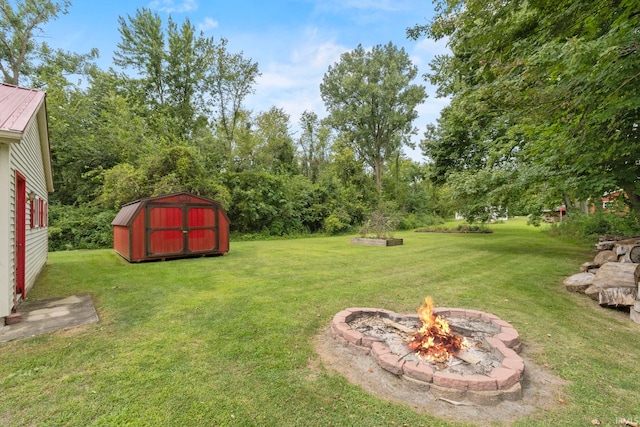 view of yard featuring a shed and a fire pit