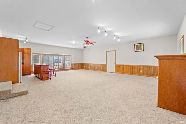 sitting room with ceiling fan, light carpet, and track lighting