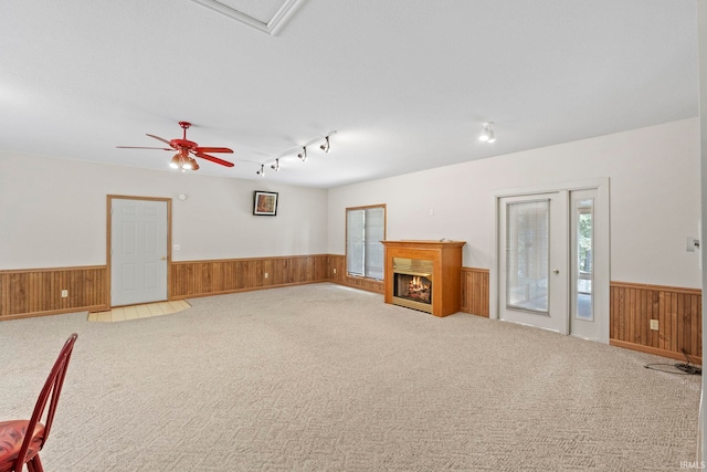 interior space with rail lighting and ceiling fan