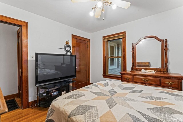 bedroom with ceiling fan and wood-type flooring