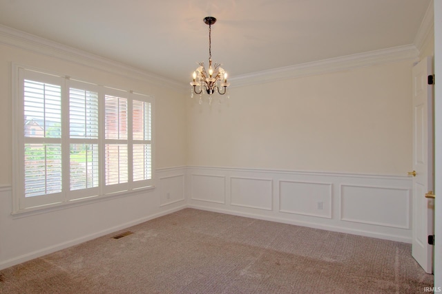 carpeted spare room with a chandelier and crown molding