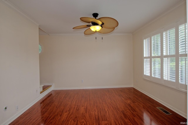 empty room featuring hardwood / wood-style floors, ornamental molding, and ceiling fan