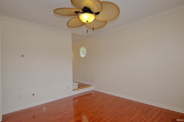 spare room featuring ceiling fan, crown molding, and wood-type flooring