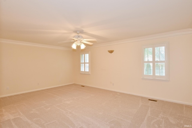 carpeted empty room featuring crown molding and ceiling fan