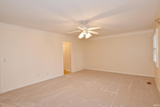 carpeted empty room featuring crown molding and ceiling fan