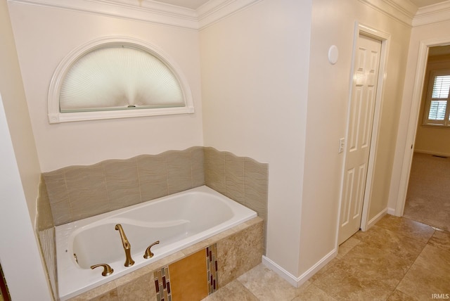 bathroom with tiled bath, ornamental molding, and tile patterned floors