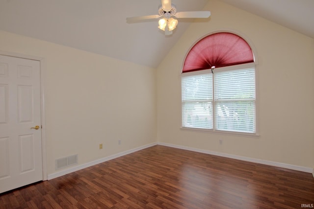 empty room featuring ceiling fan, dark hardwood / wood-style flooring, and vaulted ceiling