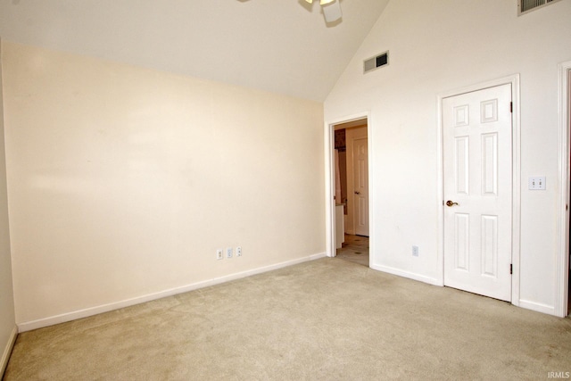 unfurnished bedroom featuring light carpet and high vaulted ceiling