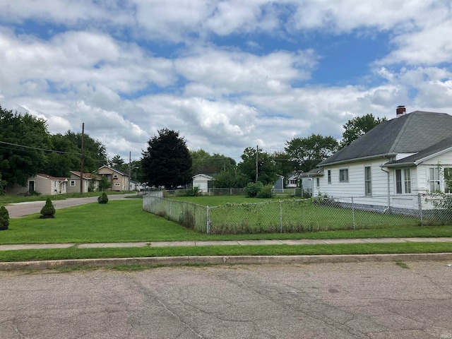 view of side of home with a yard