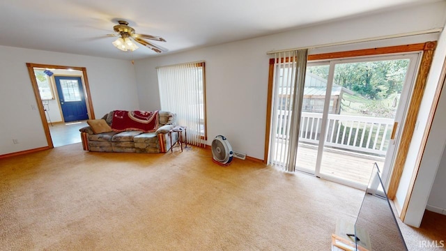 sitting room featuring carpet floors, a ceiling fan, and baseboards