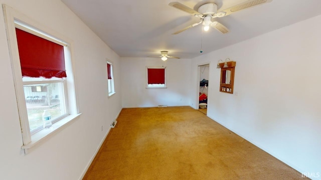 unfurnished room with light carpet and ceiling fan