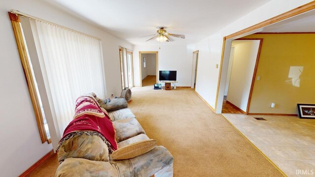 living room featuring ceiling fan and light tile patterned floors