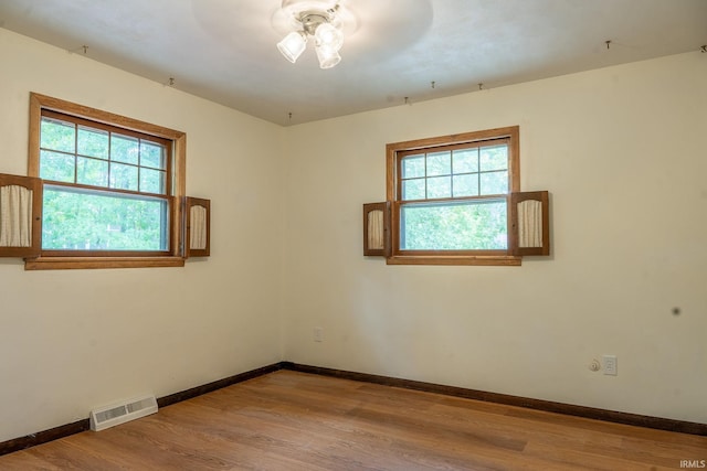 empty room with ceiling fan and light wood-type flooring