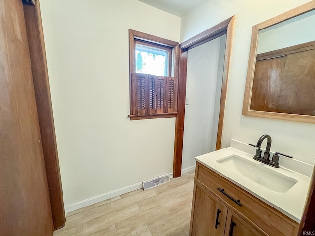 bathroom featuring hardwood / wood-style floors and vanity