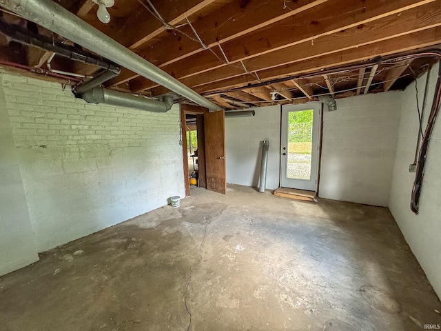 basement featuring brick wall