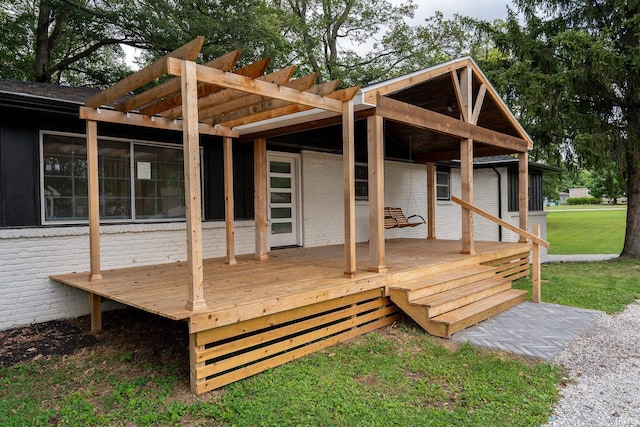 wooden deck with a lawn and a pergola