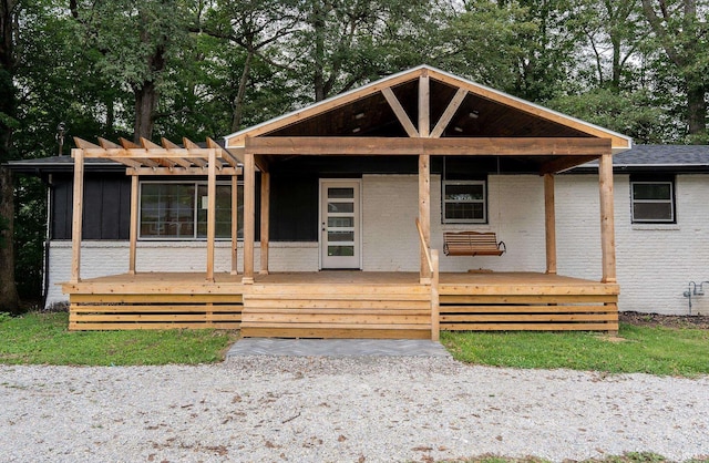 view of front of property with a pergola and a wooden deck