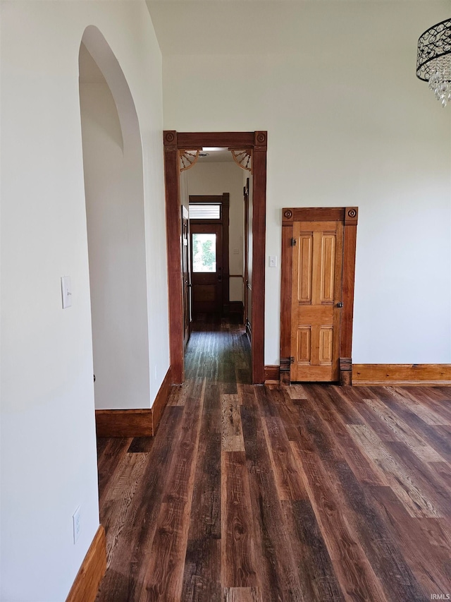 hallway with dark hardwood / wood-style flooring