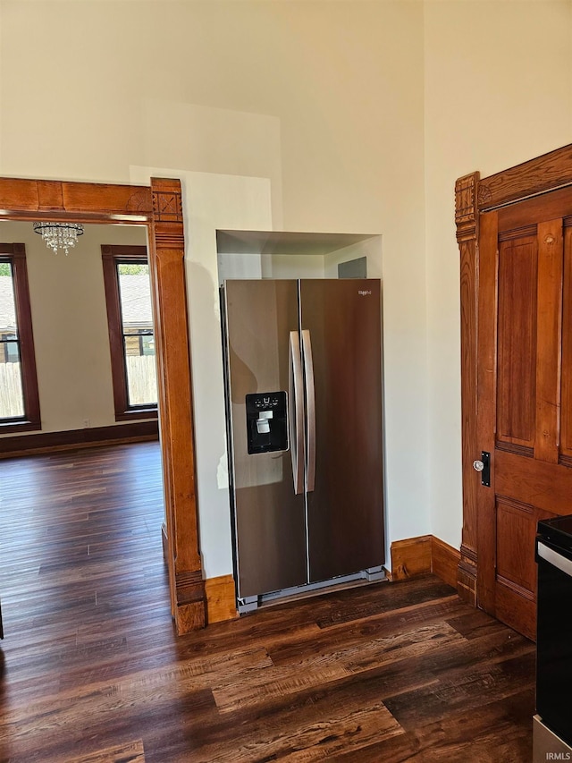 kitchen featuring stainless steel fridge, range with electric cooktop, and dark hardwood / wood-style flooring