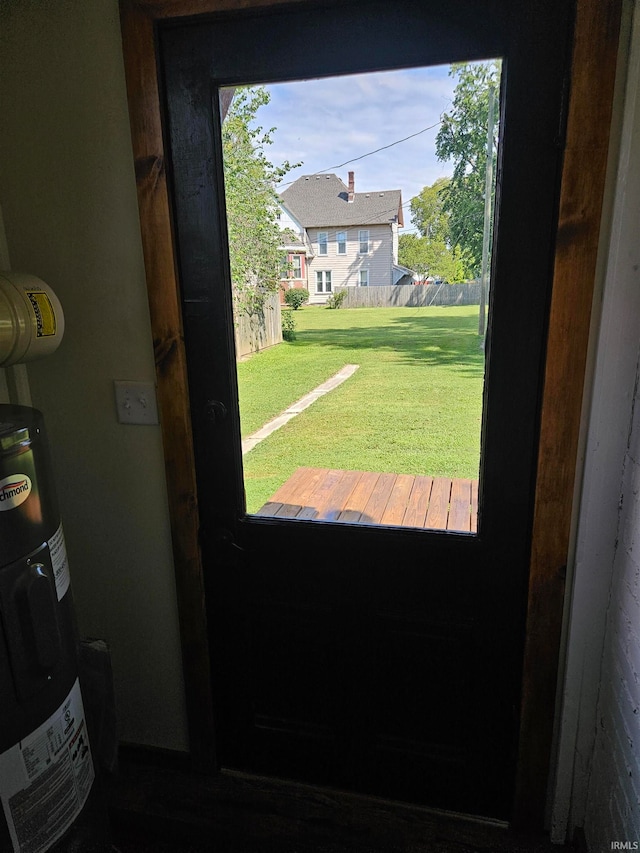 doorway with water heater and a wealth of natural light