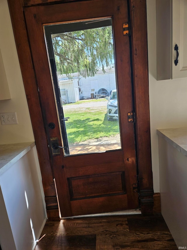 doorway with dark hardwood / wood-style floors