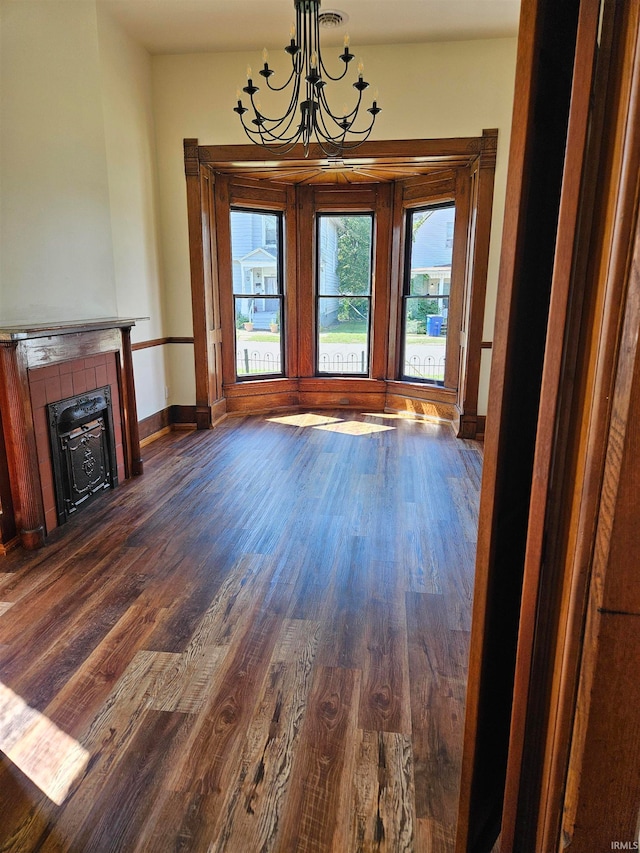 interior space with a fireplace, dark hardwood / wood-style flooring, and a chandelier