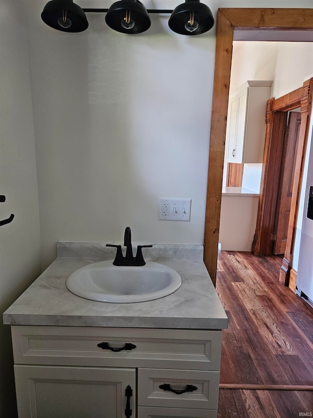 bathroom with hardwood / wood-style flooring and vanity