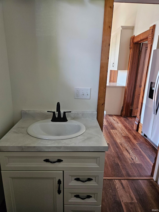 bathroom with hardwood / wood-style flooring and vanity