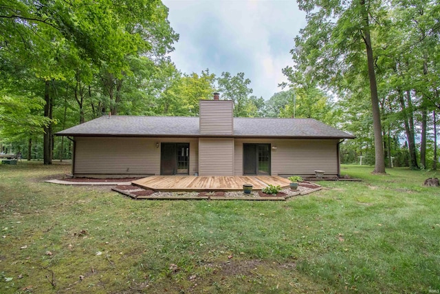 back of property featuring a yard and a wooden deck