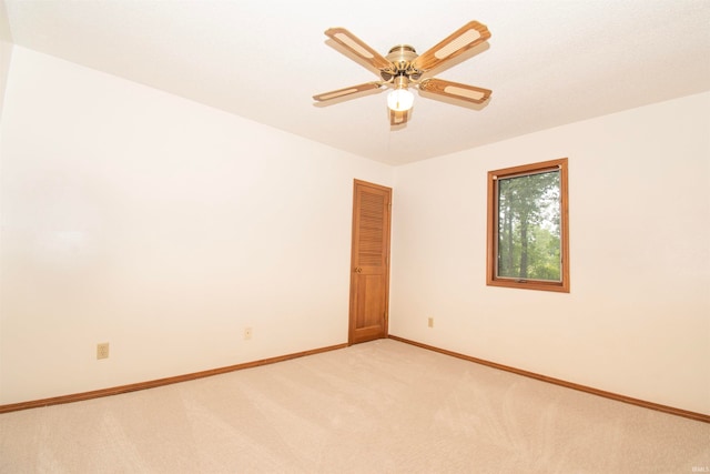 empty room with light colored carpet and ceiling fan