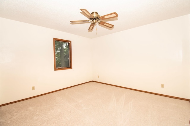 unfurnished room featuring ceiling fan and carpet floors