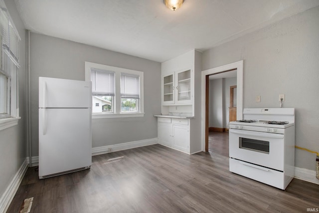 kitchen featuring white cabinets, white appliances, and hardwood / wood-style flooring