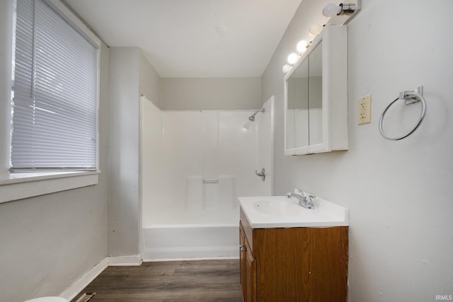 bathroom with hardwood / wood-style floors, tub / shower combination, and vanity