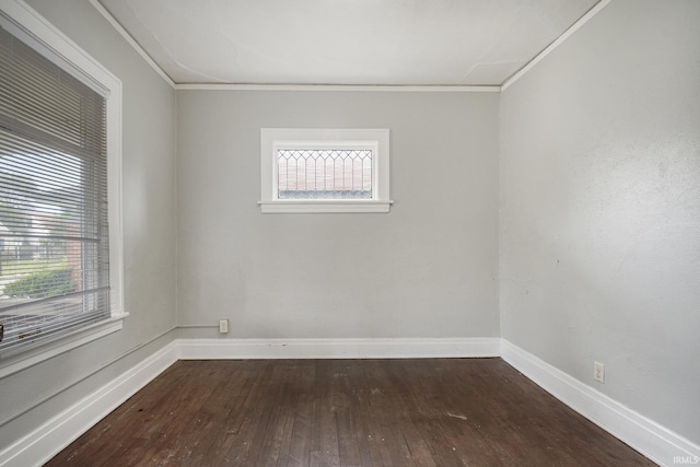 unfurnished room featuring ornamental molding and dark hardwood / wood-style floors