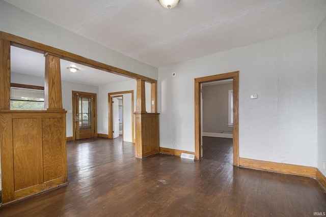 spare room with dark wood-type flooring