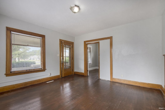 spare room featuring dark hardwood / wood-style floors