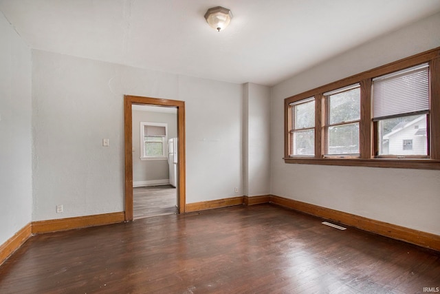 spare room with hardwood / wood-style floors and a wealth of natural light