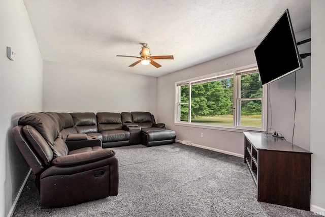 living room featuring ceiling fan, a textured ceiling, and light colored carpet