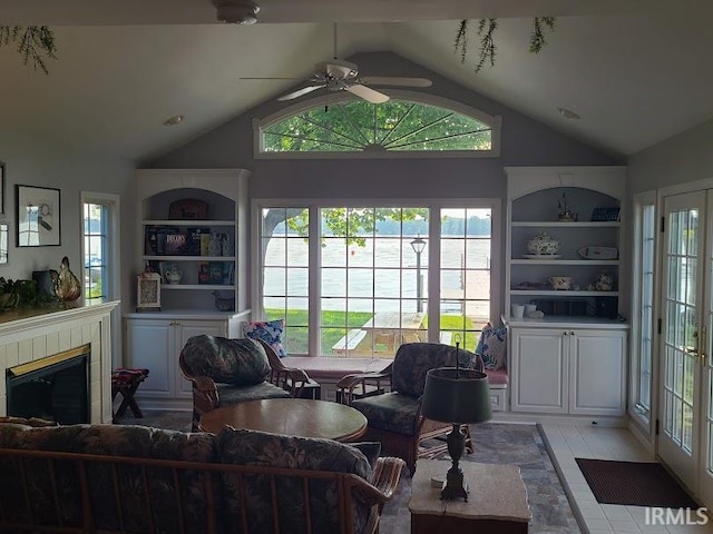 living room with light wood-type flooring, ceiling fan, and plenty of natural light