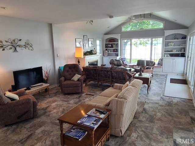 living room featuring built in shelves, lofted ceiling, and ceiling fan