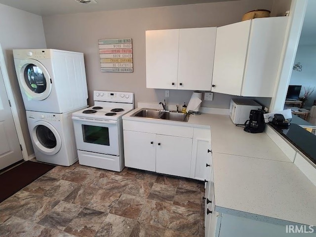 washroom with stacked washing maching and dryer and sink