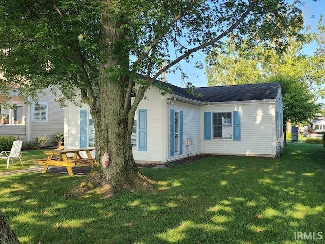 rear view of property featuring a yard