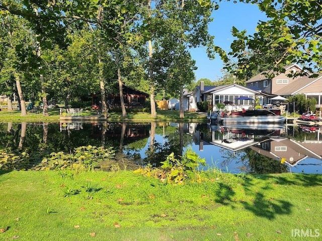 exterior space featuring a lawn and a water view