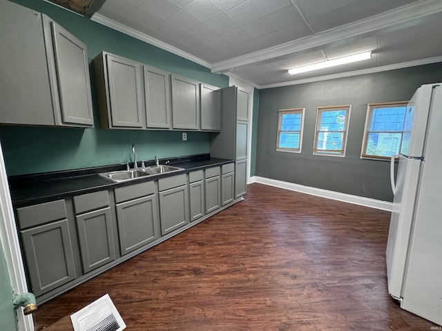 kitchen featuring gray cabinets, dark hardwood / wood-style flooring, and white fridge