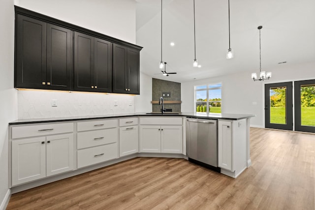 kitchen featuring pendant lighting, ceiling fan with notable chandelier, sink, dishwasher, and white cabinetry